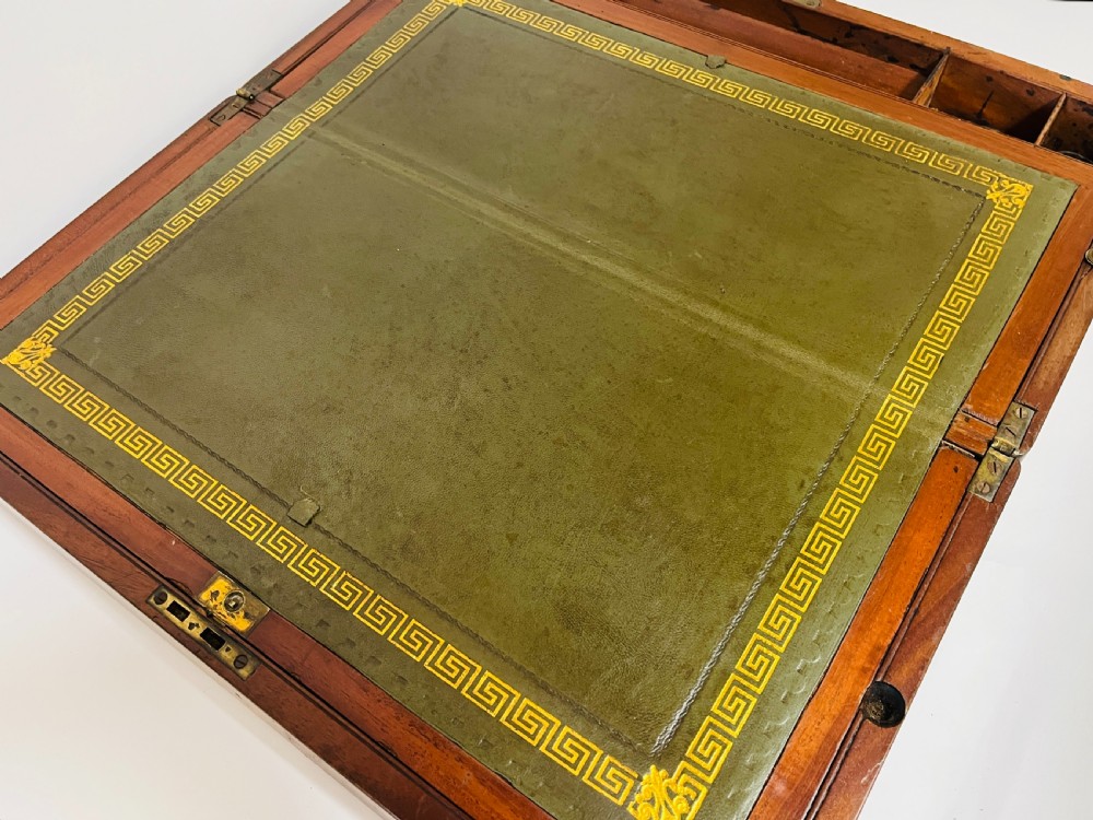 A rectangular mahogany wooden writing slope featuring protective brass corner brackets, brass straps, a central brass plaque, and a brass keyhole escutcheon. View VIII