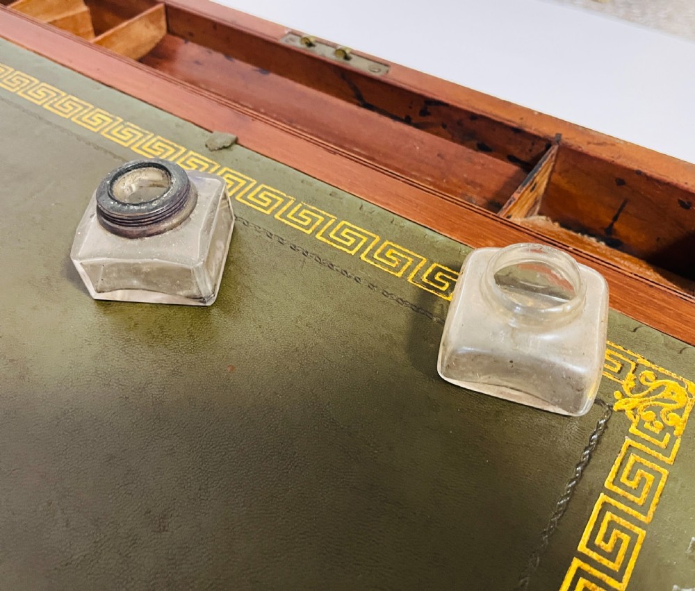A rectangular mahogany wooden writing slope featuring protective brass corner brackets, brass straps, a central brass plaque, and a brass keyhole escutcheon. View IX