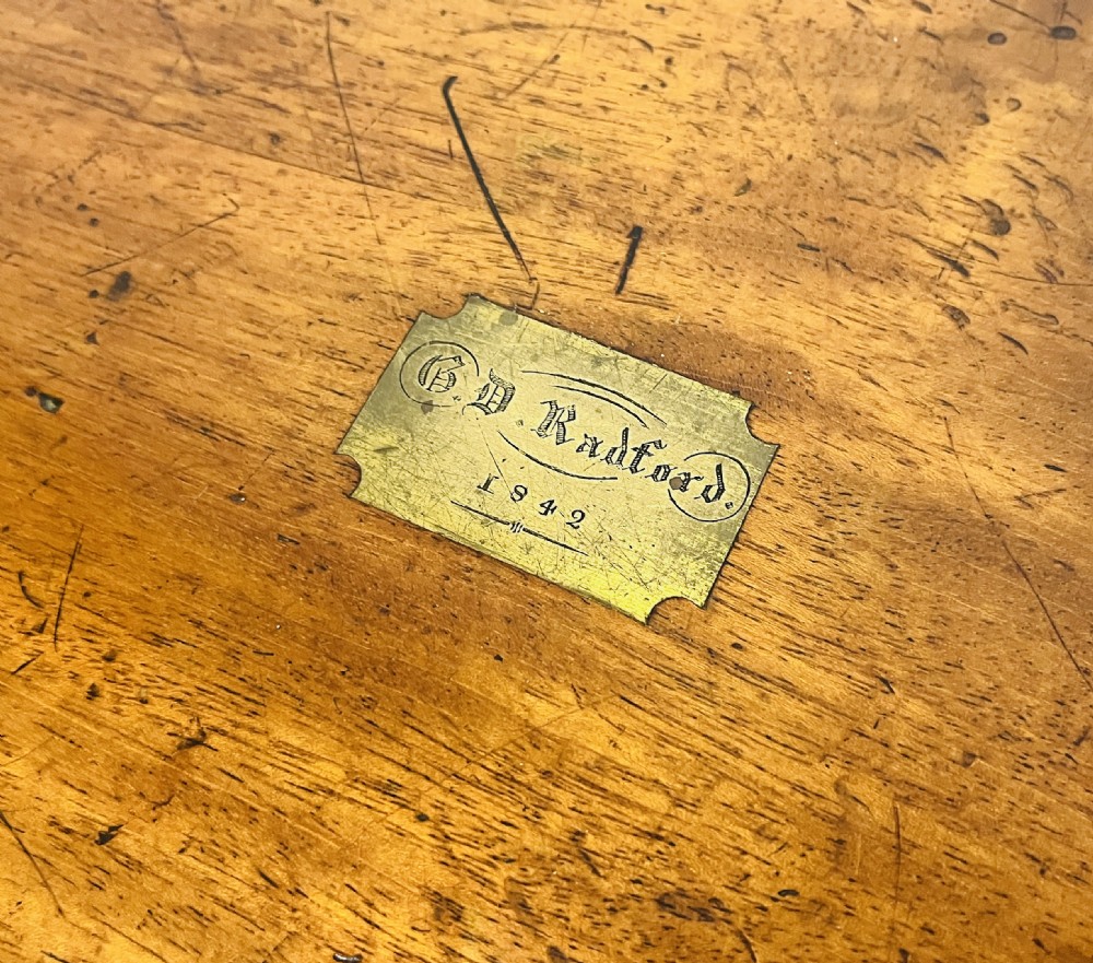 A rectangular mahogany wooden writing slope featuring protective brass corner brackets, brass straps, a central brass plaque, and a brass keyhole escutcheon. View XVI