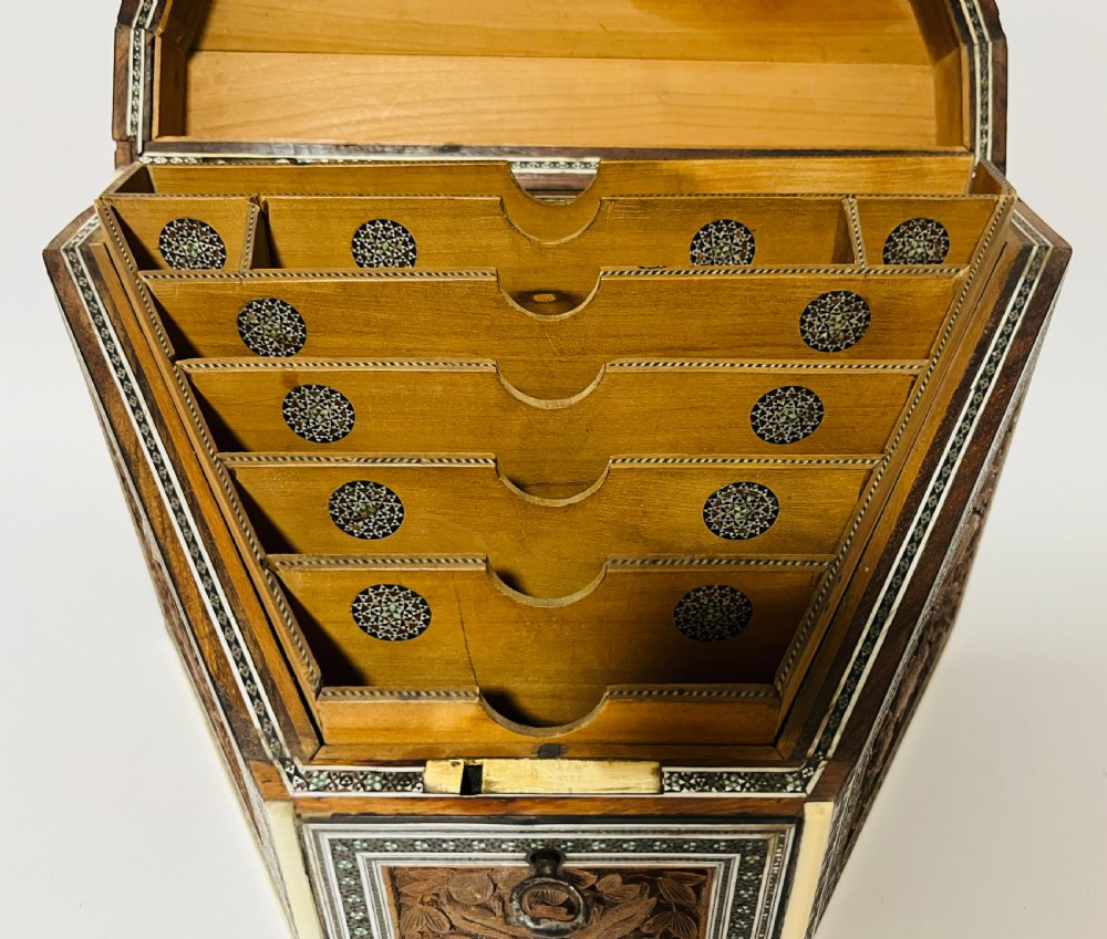 A slanted Anglo-Indian stationery box crafted from carved dark wood featuring intricate geometric bone inlay borders and relief floral panels. View VI