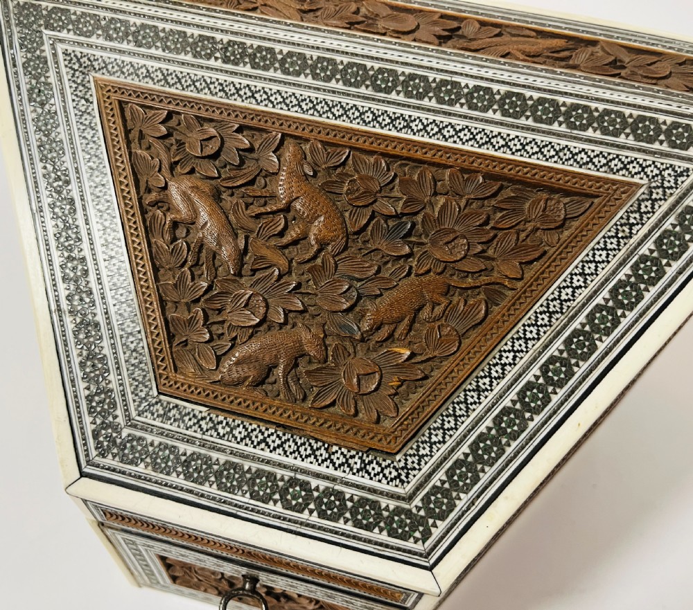 A slanted Anglo-Indian stationery box crafted from carved dark wood featuring intricate geometric bone inlay borders and relief floral panels. View VIII