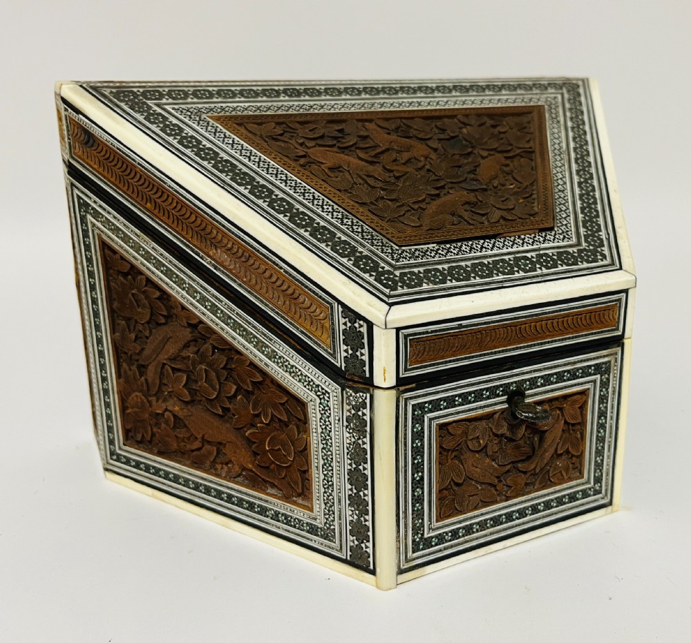 A slanted Anglo-Indian stationery box crafted from carved dark wood featuring intricate geometric bone inlay borders and relief floral panels. View IX