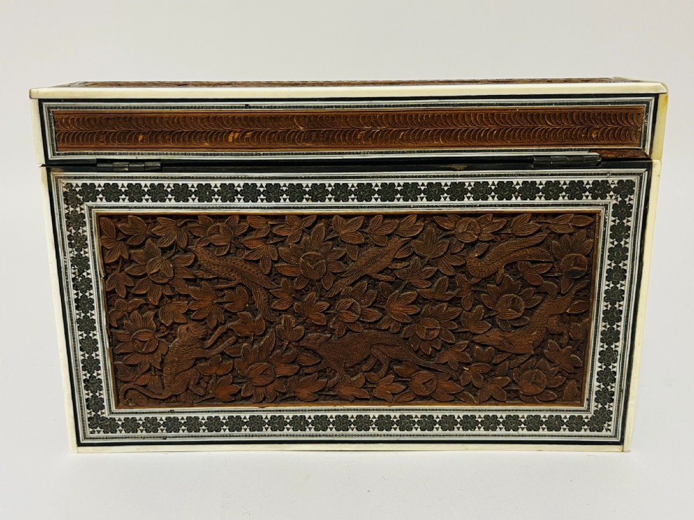 A slanted Anglo-Indian stationery box crafted from carved dark wood featuring intricate geometric bone inlay borders and relief floral panels. View XIII