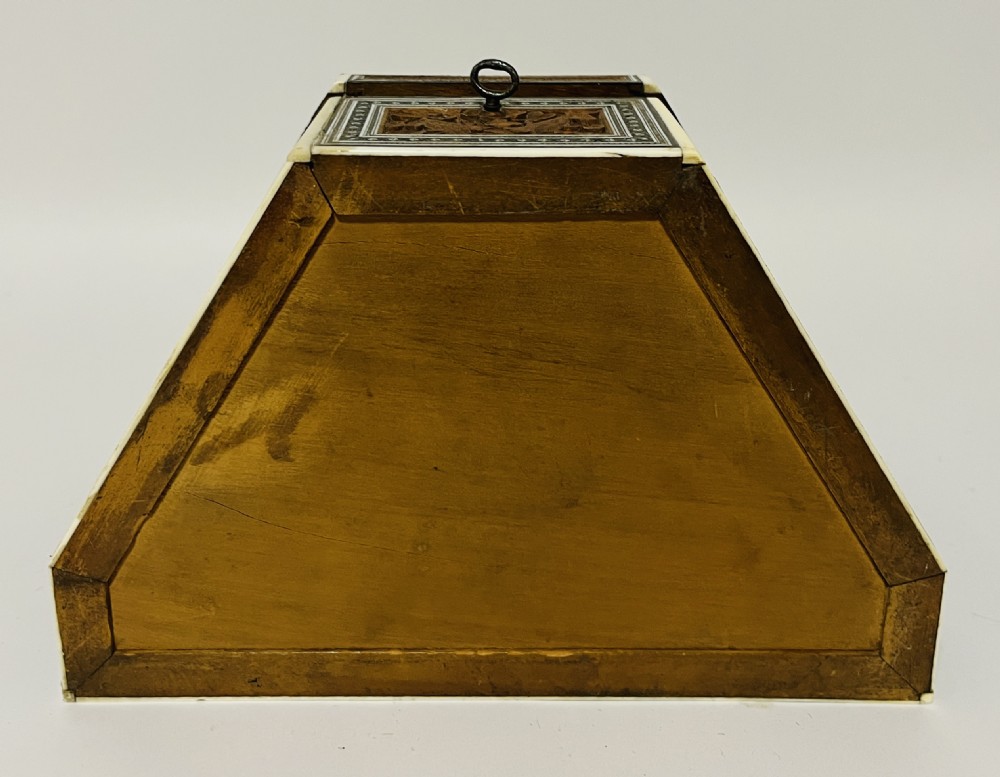 A slanted Anglo-Indian stationery box crafted from carved dark wood featuring intricate geometric bone inlay borders and relief floral panels. View XVI
