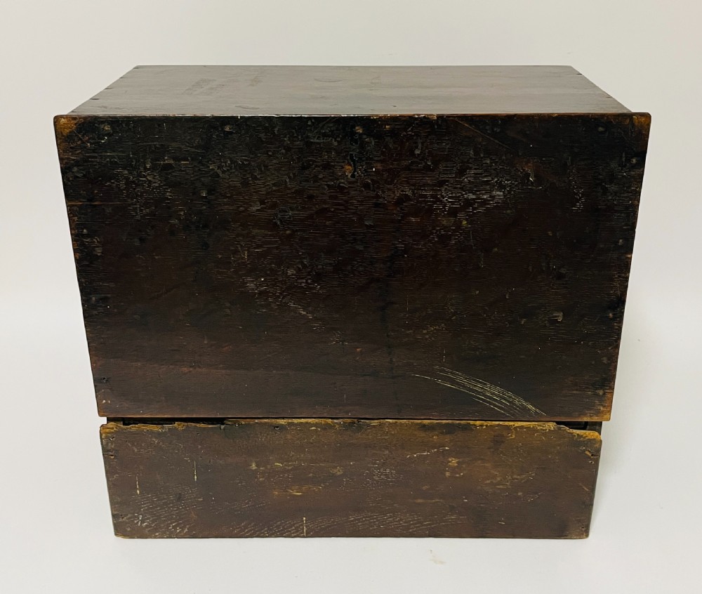 An 18th-century dark oak spice cabinet featuring multiple small drawers surrounding a central drawer, fitted with brass ring pulls. View VIII