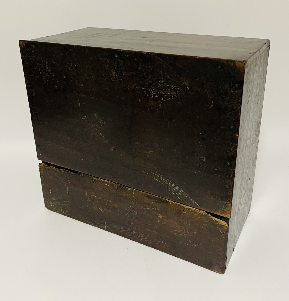 An 18th-century dark oak spice cabinet featuring multiple small drawers surrounding a central drawer, fitted with brass ring pulls. View IX