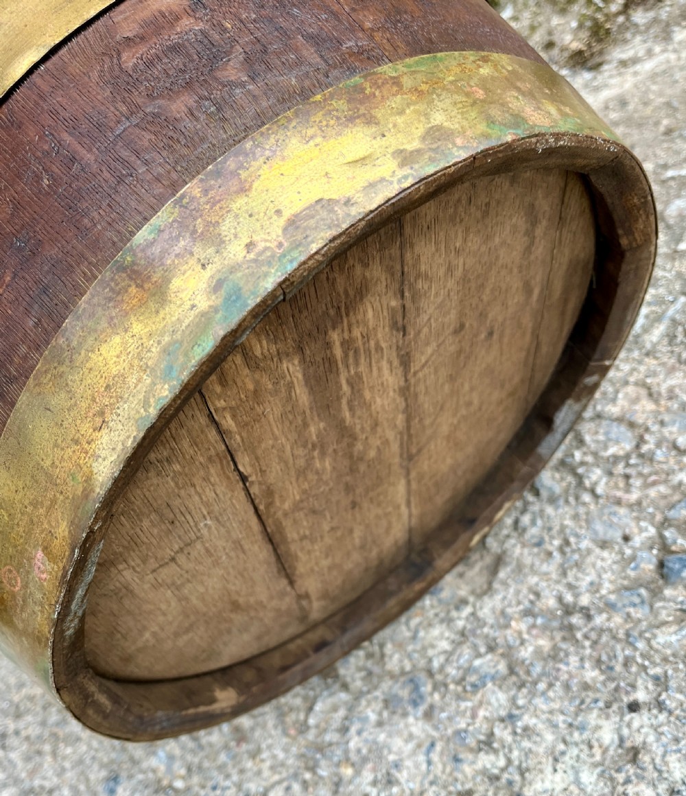 An antique coopered oak barrel featuring brass binding straps, a curved brass overhead handle, and an engraved brass presentation plaque on the front. View XI