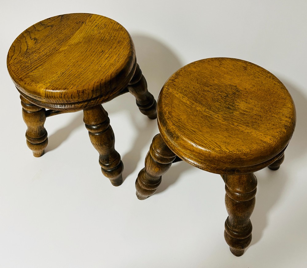 A pair of small antique oak stools with circular dished tops, turned baluster legs, and cross stretchers. View III