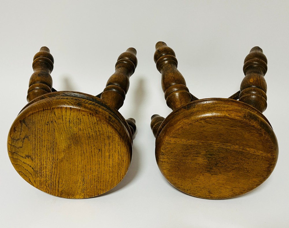 A pair of small antique oak stools with circular dished tops, turned baluster legs, and cross stretchers. View VIII