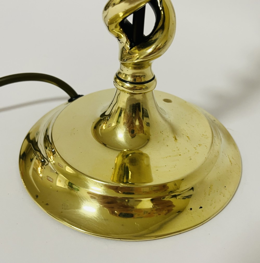 A polished brass table lamp featuring an open barley twist column set upon a round stepped base. View V