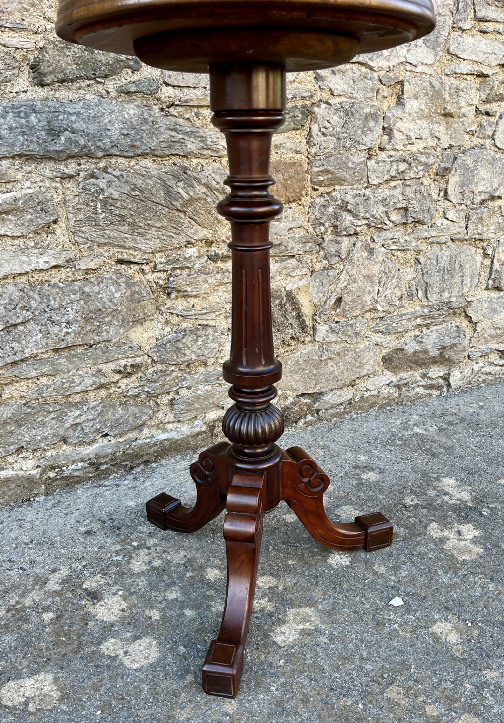 A Victorian walnut adjustable shaving stand with a circular mirror mounted on a brass stem above a small circular tabletop and turned pedestal tripod base. View II