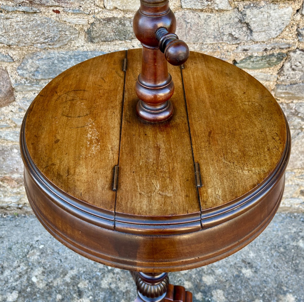 A Victorian walnut adjustable shaving stand with a circular mirror mounted on a brass stem above a small circular tabletop and turned pedestal tripod base. View IV