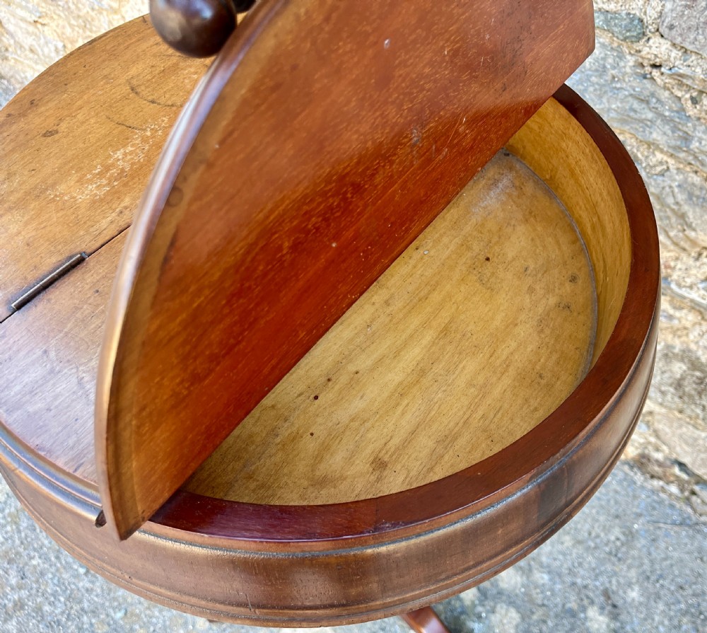 A Victorian walnut adjustable shaving stand with a circular mirror mounted on a brass stem above a small circular tabletop and turned pedestal tripod base. View V