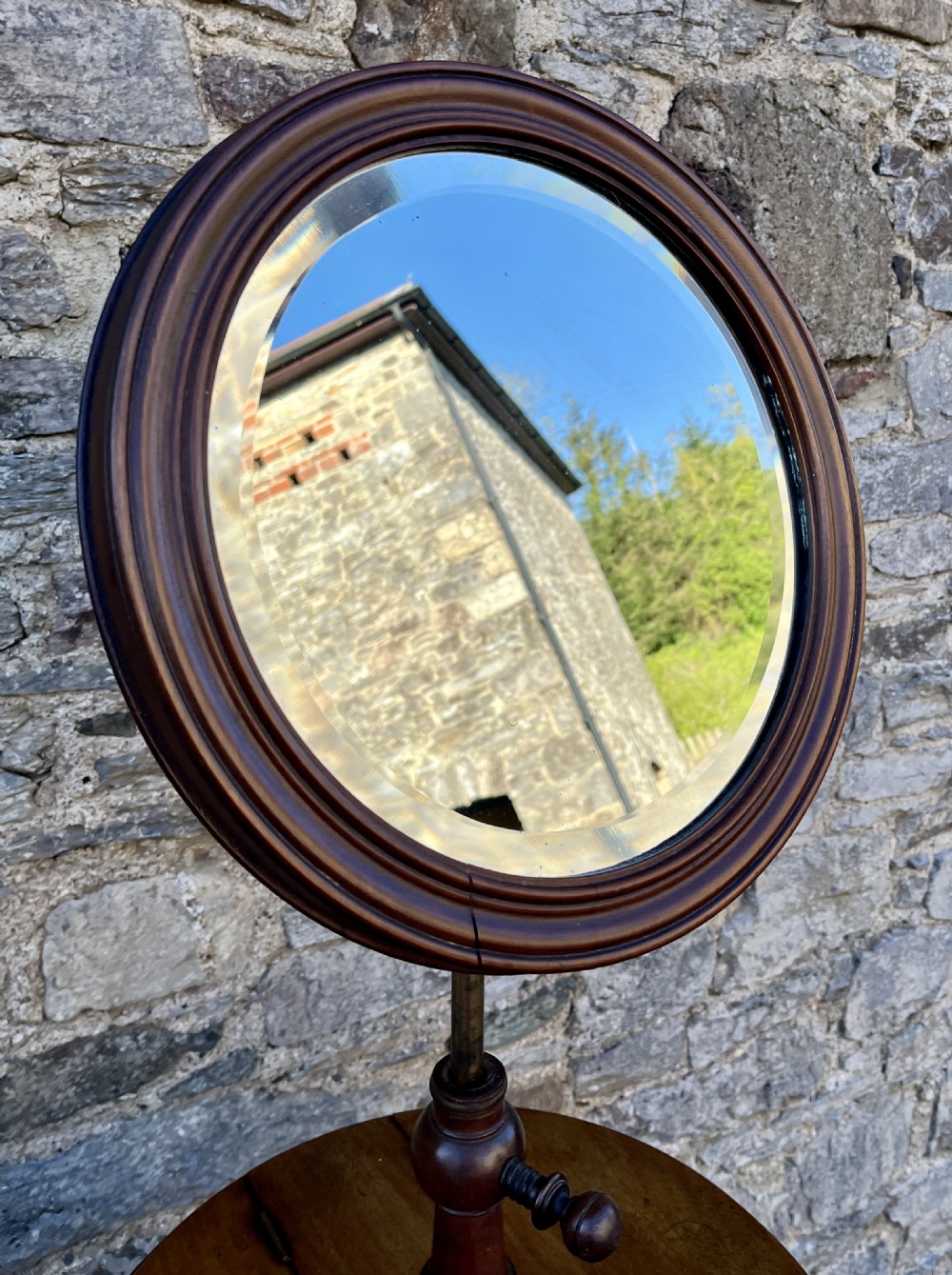 A Victorian walnut adjustable shaving stand with a circular mirror mounted on a brass stem above a small circular tabletop and turned pedestal tripod base. View VIII