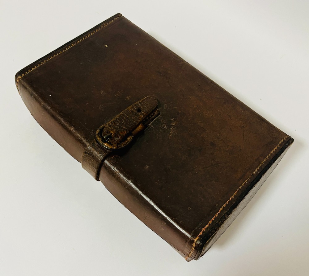 An open Victorian brown leather apothecary case revealing fitted compartments containing glass medicine bottles with stoppers and small metal tins. View IX
