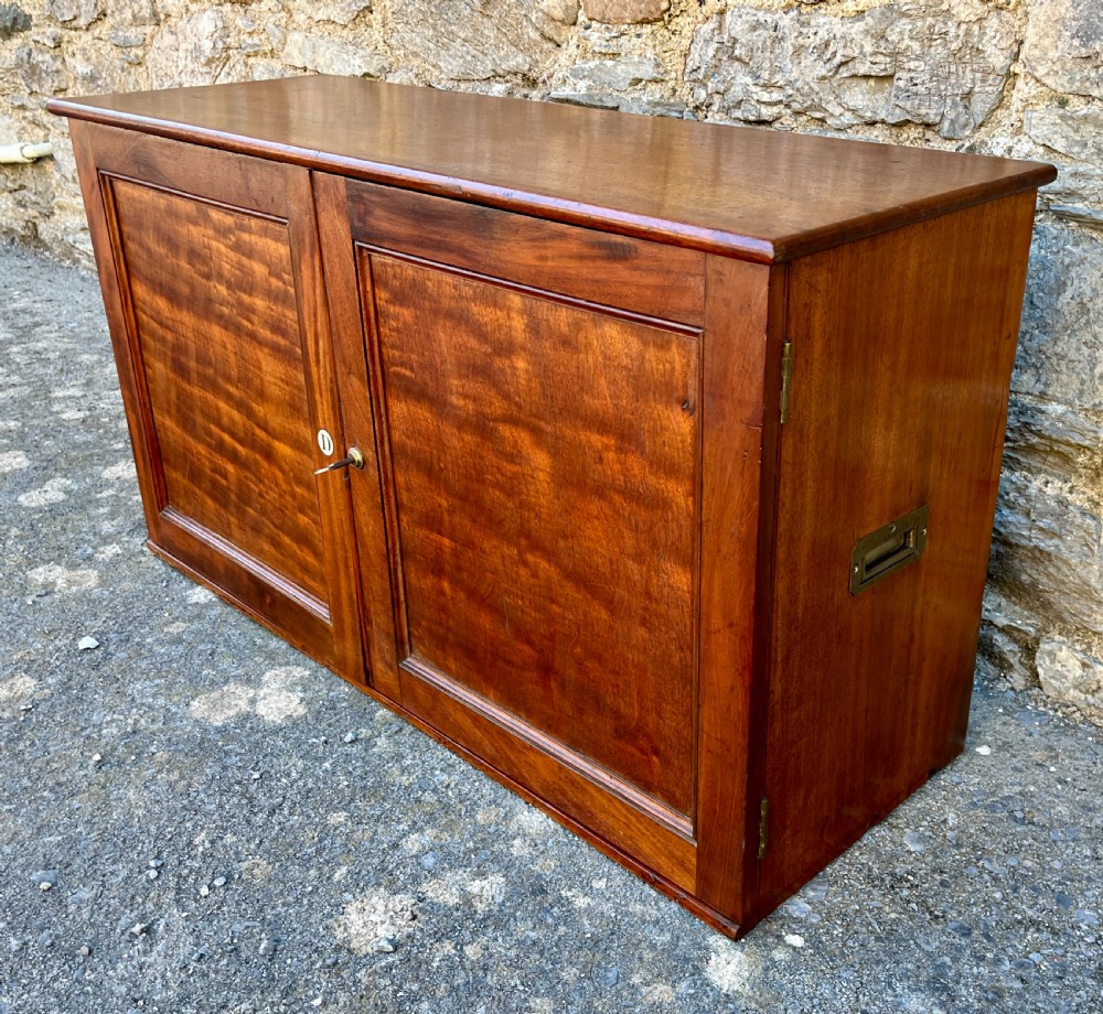 A low Victorian mahogany filing cabinet featuring twin panelled doors with flame mahogany veneer and a central keyhole. View III