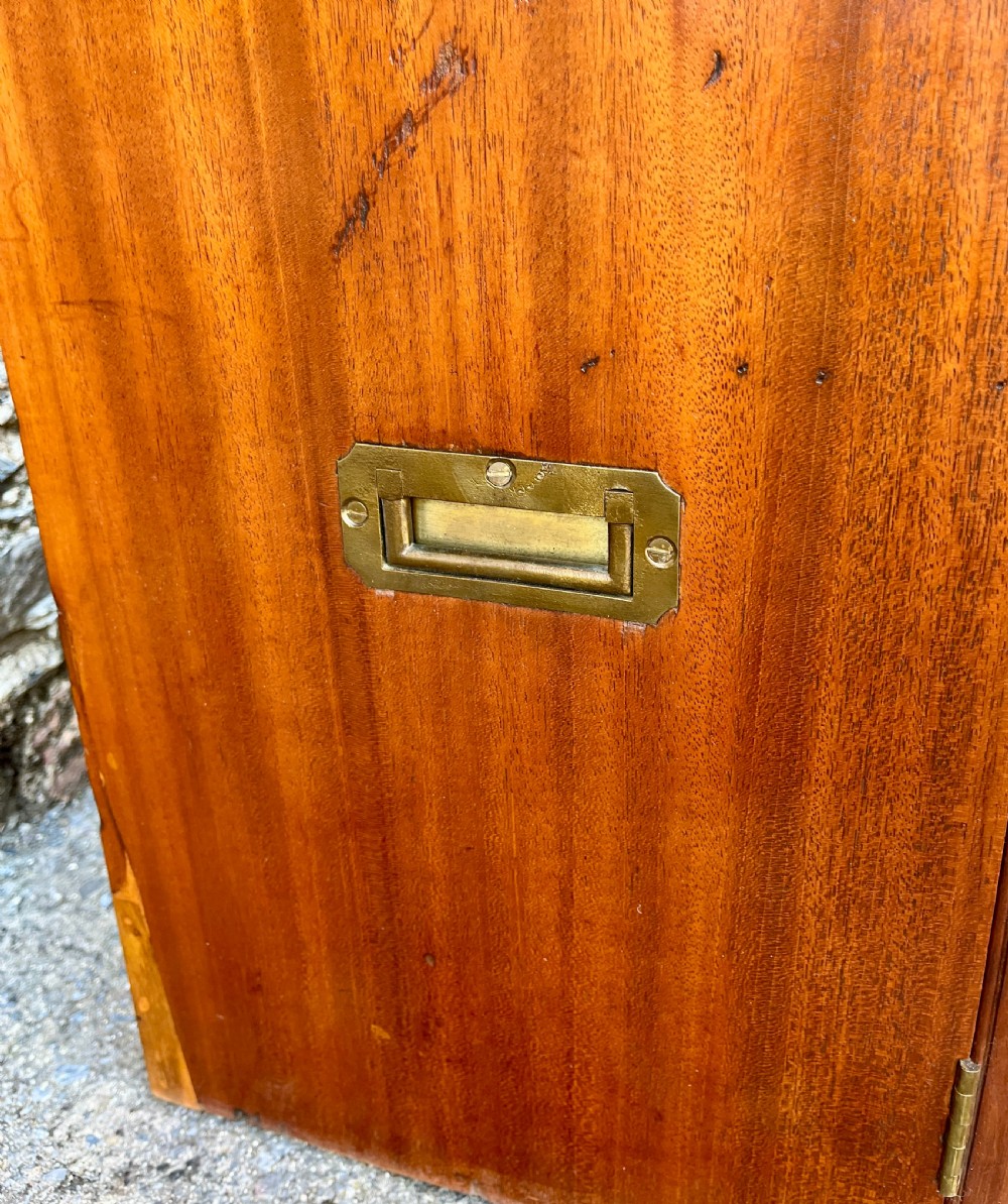 A low Victorian mahogany filing cabinet featuring twin panelled doors with flame mahogany veneer and a central keyhole. View IV
