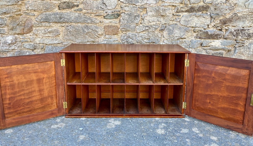 A low Victorian mahogany filing cabinet featuring twin panelled doors with flame mahogany veneer and a central keyhole. View VIII