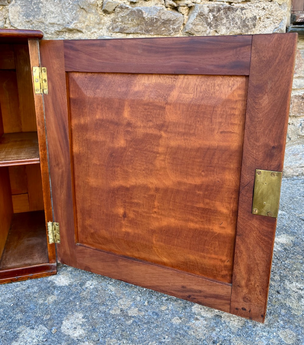 A low Victorian mahogany filing cabinet featuring twin panelled doors with flame mahogany veneer and a central keyhole. View XI