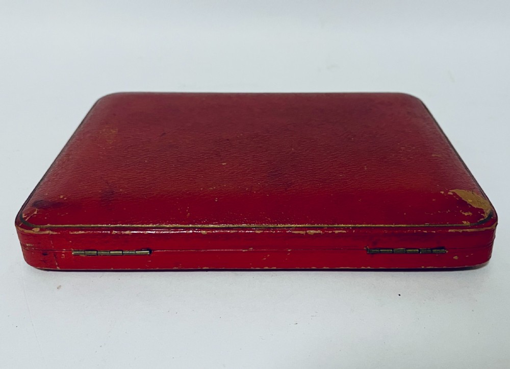 A set of six antique silver dessert knives with iridescent mother-of-pearl handles presented inside an open red velvet-lined presentation case. View VI