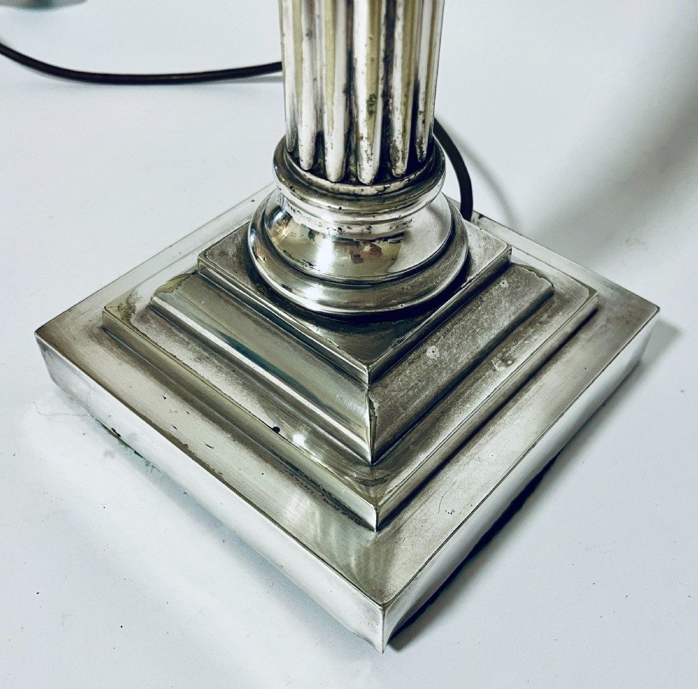 A Victorian silver-plated table lamp designed as a fluted Corinthian column with a stepped square base. View II
