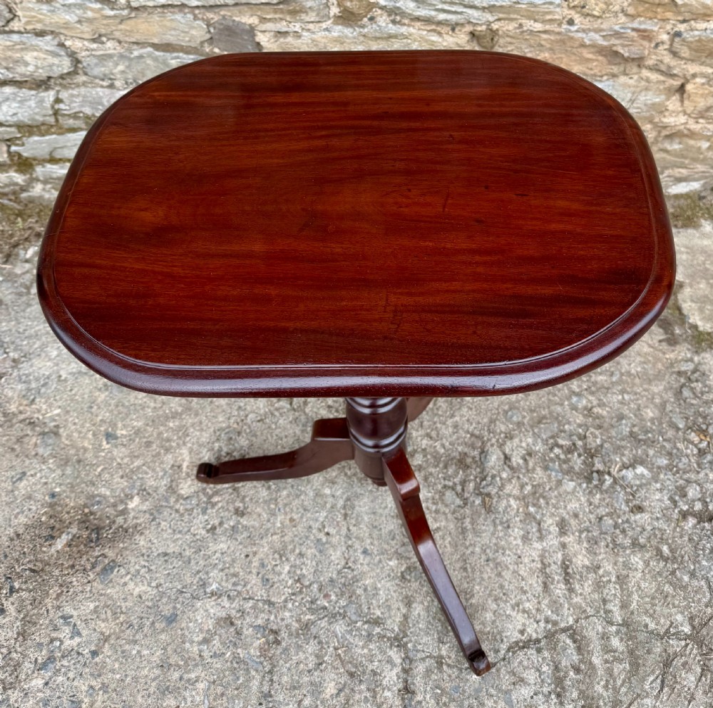 A Victorian dark mahogany wine table featuring a rounded rectangular top, a central turned baluster column, and a tripod base. View II