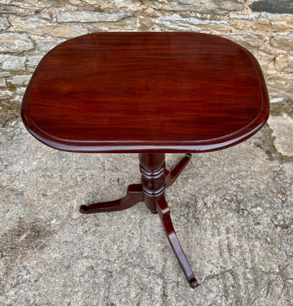 A Victorian dark mahogany wine table featuring a rounded rectangular top, a central turned baluster column, and a tripod base. View III
