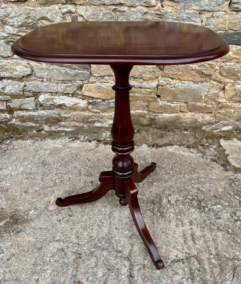 A Victorian dark mahogany wine table featuring a rounded rectangular top, a central turned baluster column, and a tripod base. View IV