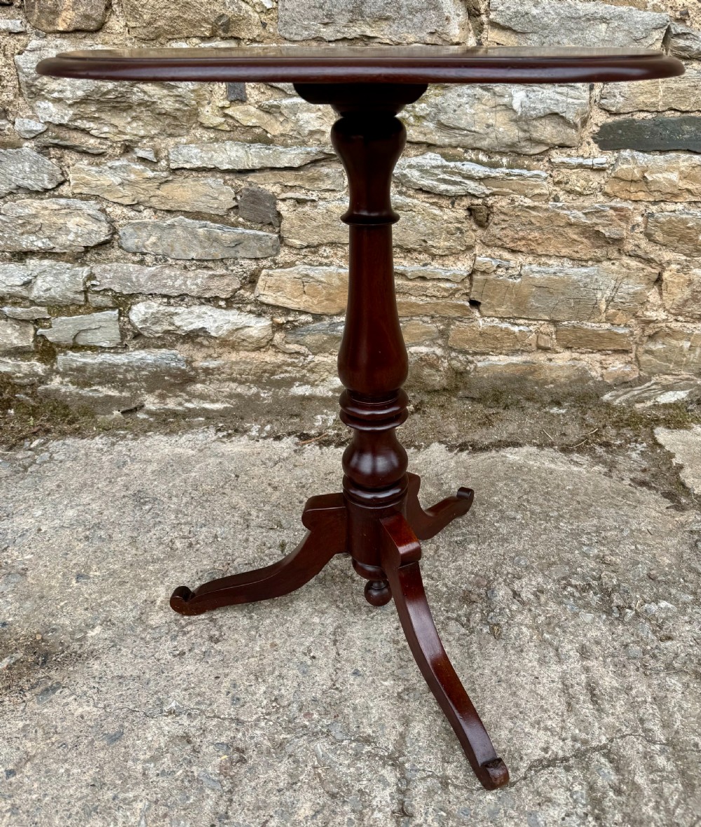 A Victorian dark mahogany wine table featuring a rounded rectangular top, a central turned baluster column, and a tripod base. View V