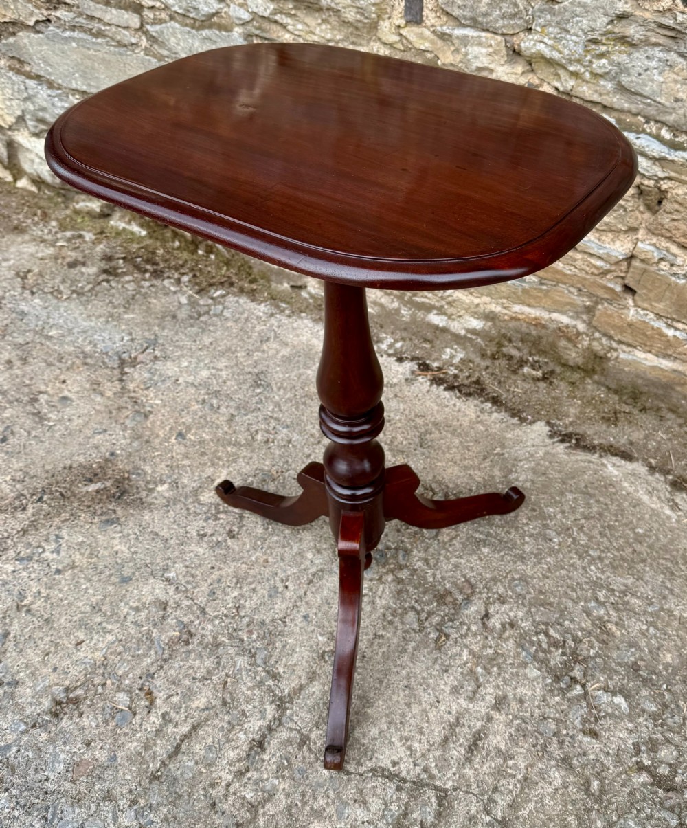 A Victorian dark mahogany wine table featuring a rounded rectangular top, a central turned baluster column, and a tripod base. View VI