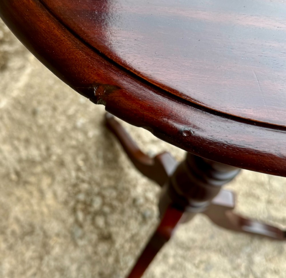 A Victorian dark mahogany wine table featuring a rounded rectangular top, a central turned baluster column, and a tripod base. View VIII