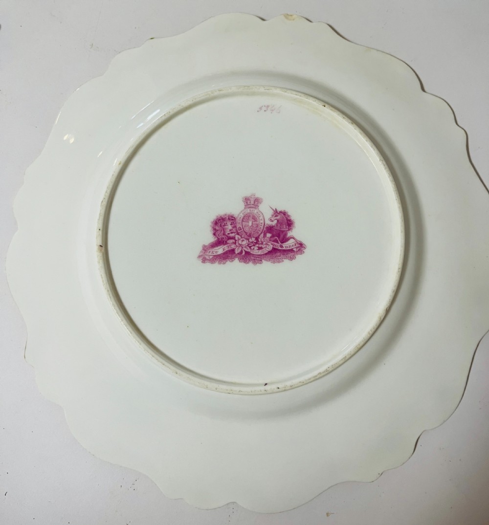 A nineteenth-century John Ridgway porcelain dessert service featuring buff-coloured borders, gilded scrollwork, reticulated handles, and hand-painted central floral garlands. View V
