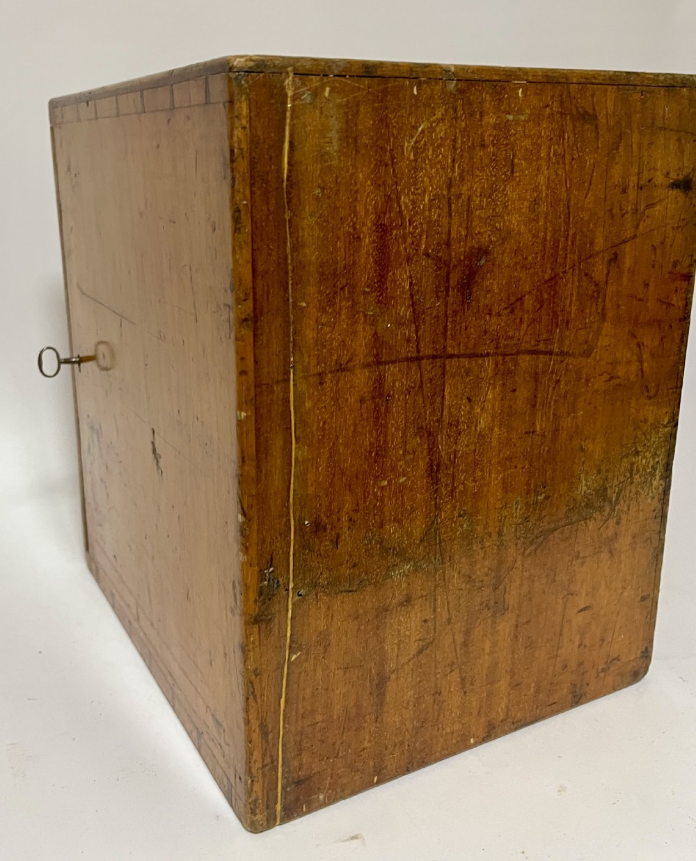 A warm brown wooden microscope slide cabinet with its single door open to reveal numerous shallow horizontal drawers with small round pulls. View XIV