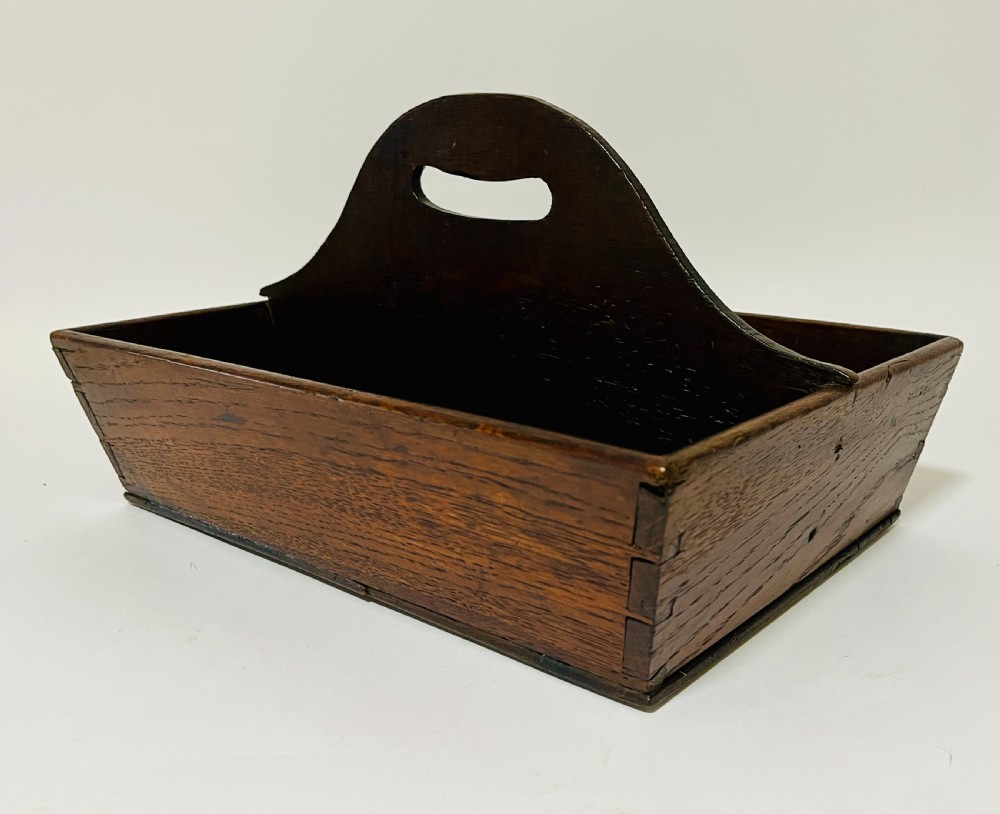 A dark brown Georgian oak cutlery tray featuring two compartments separated by a central shaped divider with a cut-out handle. View III