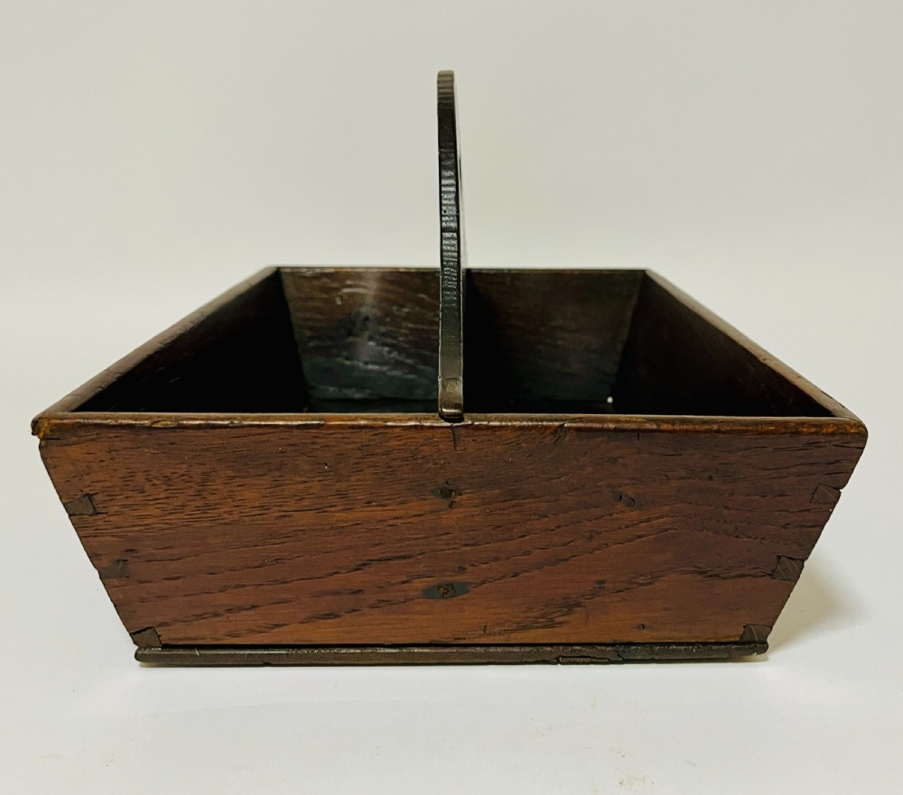 A dark brown Georgian oak cutlery tray featuring two compartments separated by a central shaped divider with a cut-out handle. View IV
