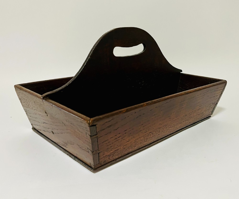 A dark brown Georgian oak cutlery tray featuring two compartments separated by a central shaped divider with a cut-out handle. View V