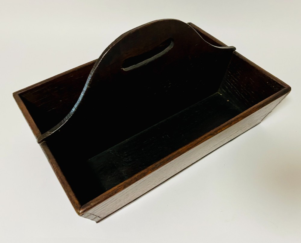 A dark brown Georgian oak cutlery tray featuring two compartments separated by a central shaped divider with a cut-out handle. View VI