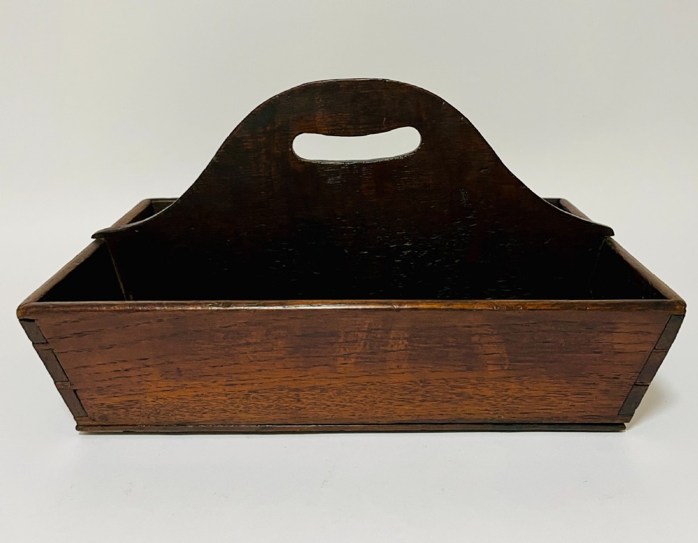 A dark brown Georgian oak cutlery tray featuring two compartments separated by a central shaped divider with a cut-out handle. View VIII