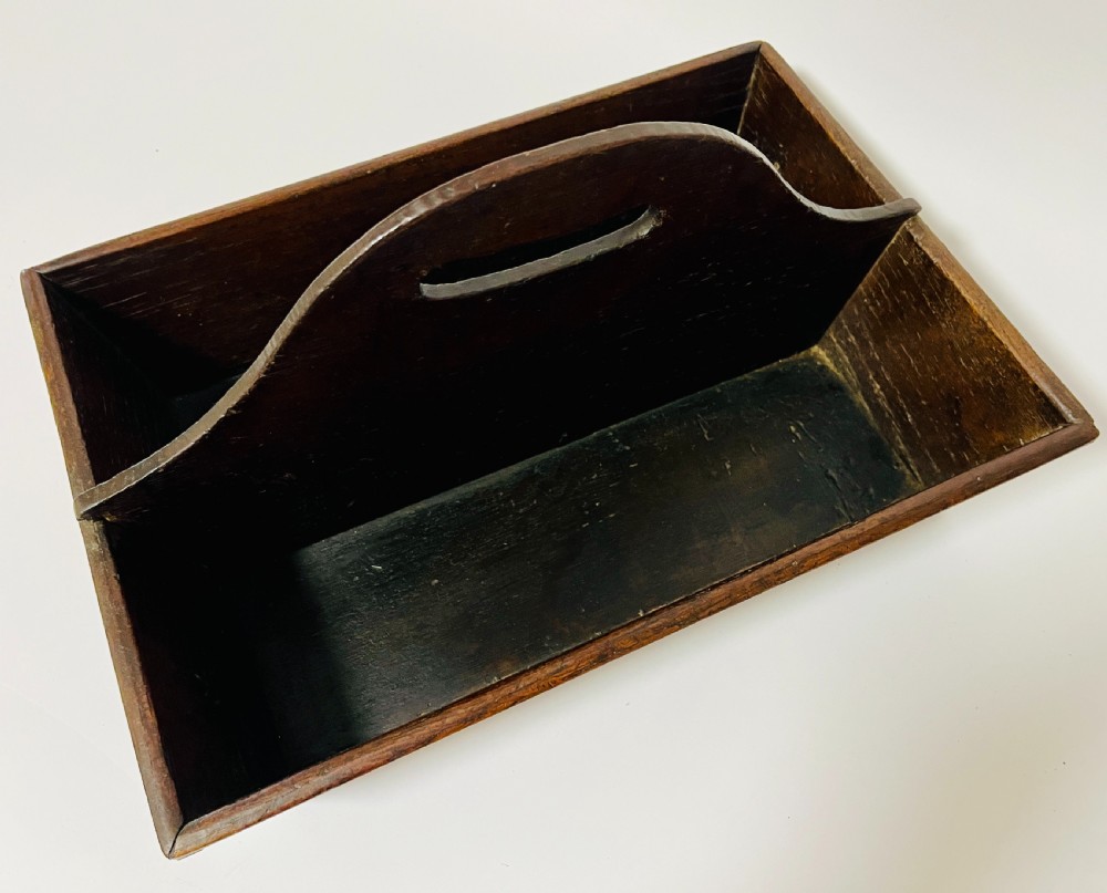 A dark brown Georgian oak cutlery tray featuring two compartments separated by a central shaped divider with a cut-out handle. View X