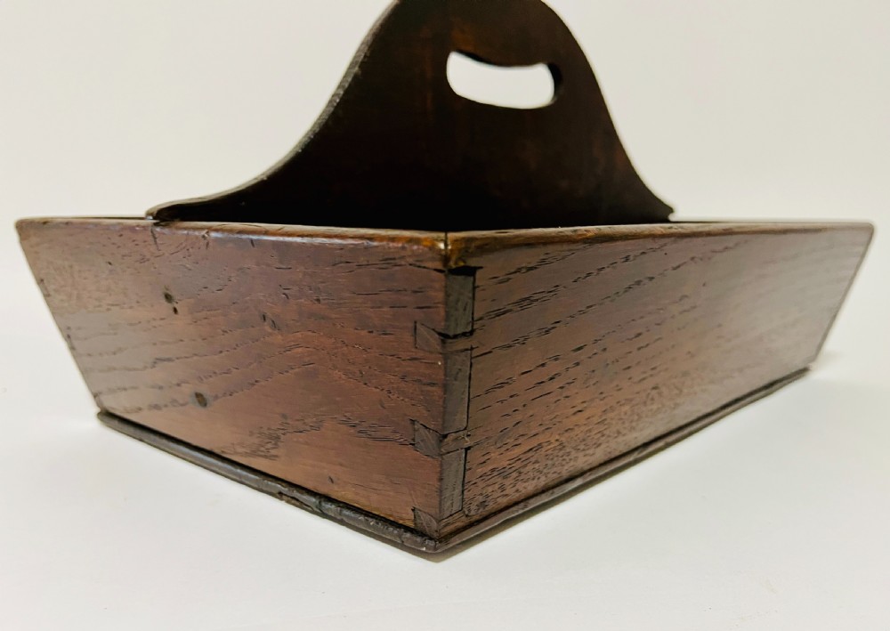 A dark brown Georgian oak cutlery tray featuring two compartments separated by a central shaped divider with a cut-out handle. View XI