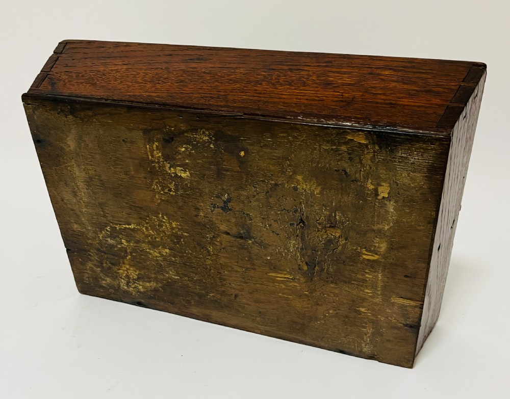 A dark brown Georgian oak cutlery tray featuring two compartments separated by a central shaped divider with a cut-out handle. View XII