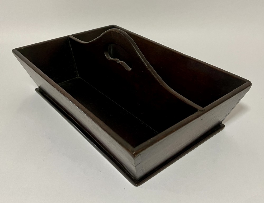 An antique Georgian dark mahogany wooden cutlery tray featuring a central division with a carved carrying handle. View II