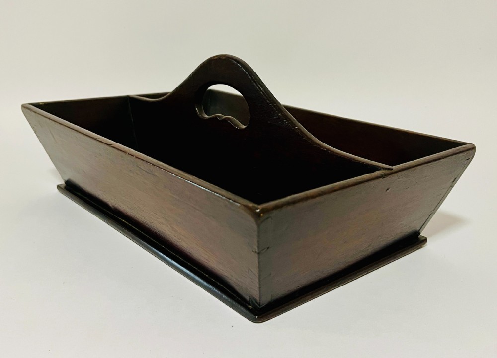 An antique Georgian dark mahogany wooden cutlery tray featuring a central division with a carved carrying handle. View III