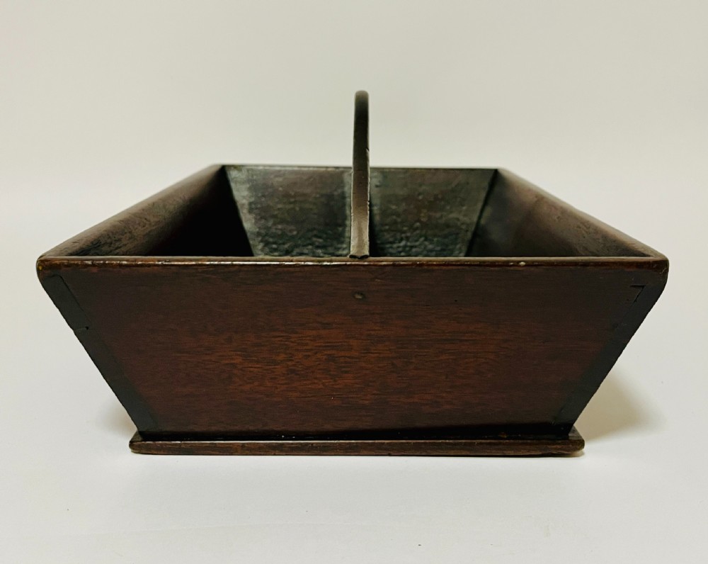 An antique Georgian dark mahogany wooden cutlery tray featuring a central division with a carved carrying handle. View IV