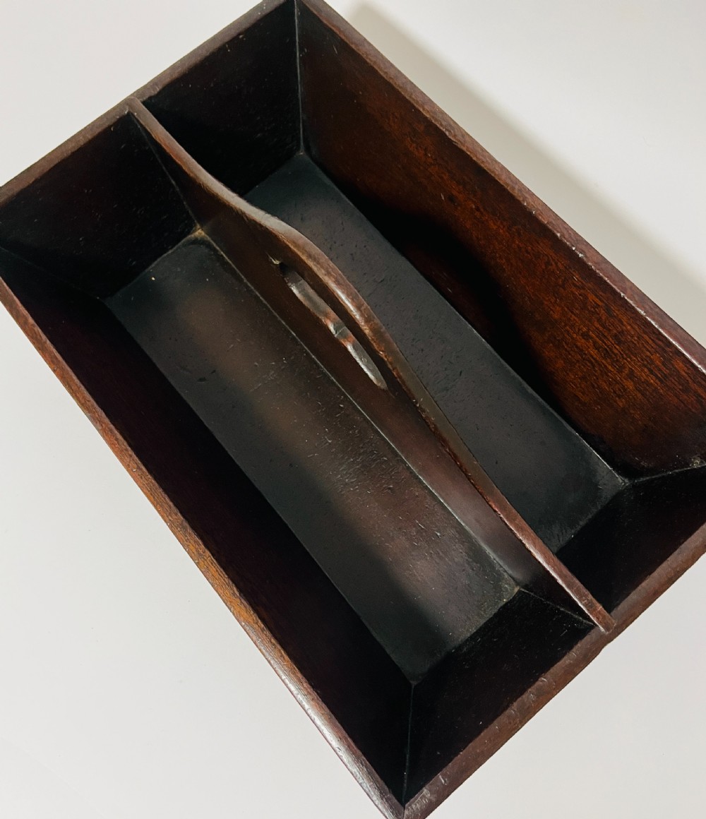 An antique Georgian dark mahogany wooden cutlery tray featuring a central division with a carved carrying handle. View VII
