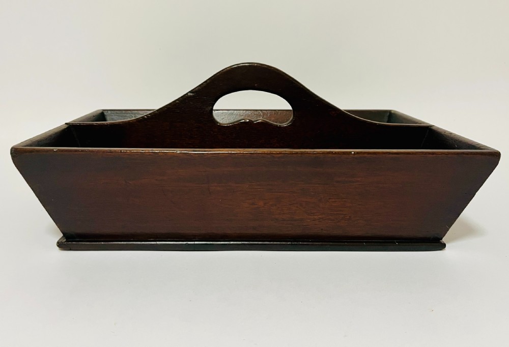 An antique Georgian dark mahogany wooden cutlery tray featuring a central division with a carved carrying handle. View VIII