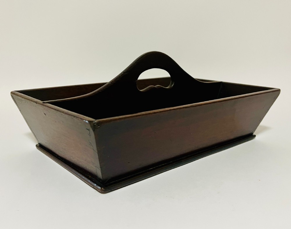 An antique Georgian dark mahogany wooden cutlery tray featuring a central division with a carved carrying handle. View IX