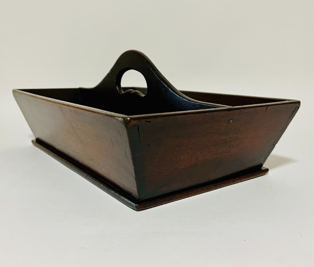 An antique Georgian dark mahogany wooden cutlery tray featuring a central division with a carved carrying handle. View X