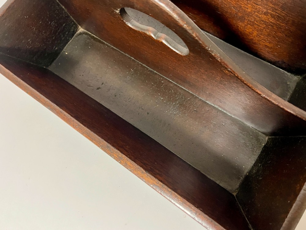 An antique Georgian dark mahogany wooden cutlery tray featuring a central division with a carved carrying handle. View XI