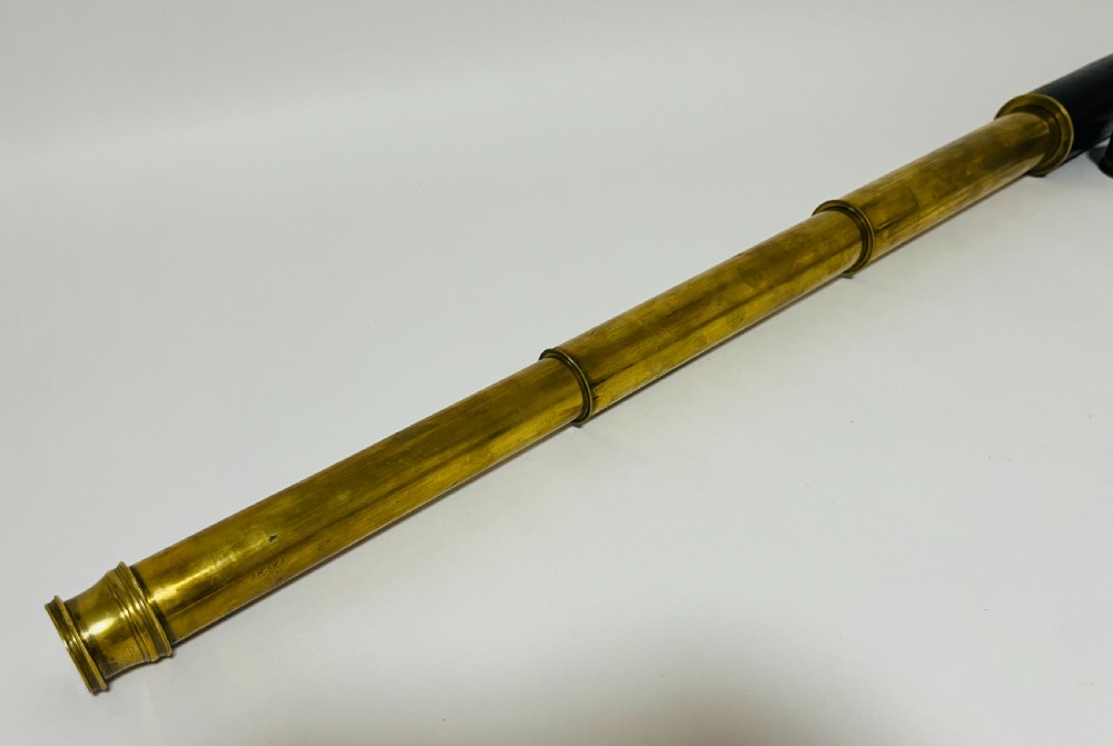 A fully extended three-draw brass telescope featuring a textured black leather sleeve around the main barrel. View VIII